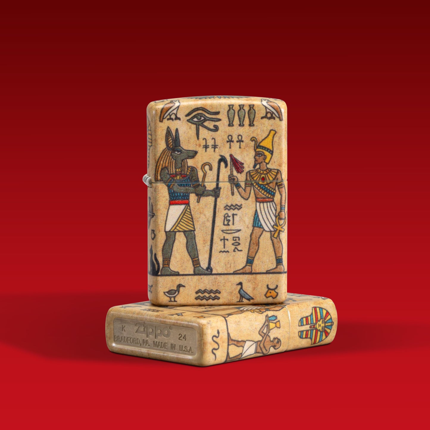 Lifestyle image of two Zippo Ancient Glyphs Design White 540 Matte Windproof Lighters; one lighter lying flat showing the non-hinge and bottom sides of the lighter, while the other lighter is standing on top of the lighter lying flat showing the front of the lighter. 