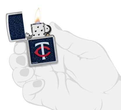 Zippo MLB® Minnesota Twins Street Chrome Windproof Lighter lit in hand.