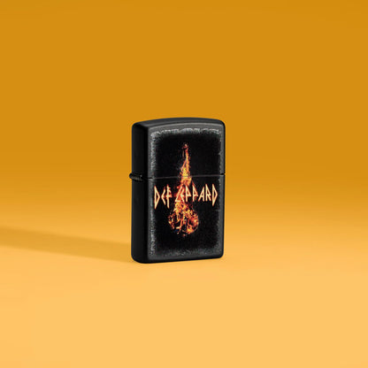 Lifestyle image of Zippo Def Leppard Burning Violin Black Matte Windproof Lighter standing on an orange background.