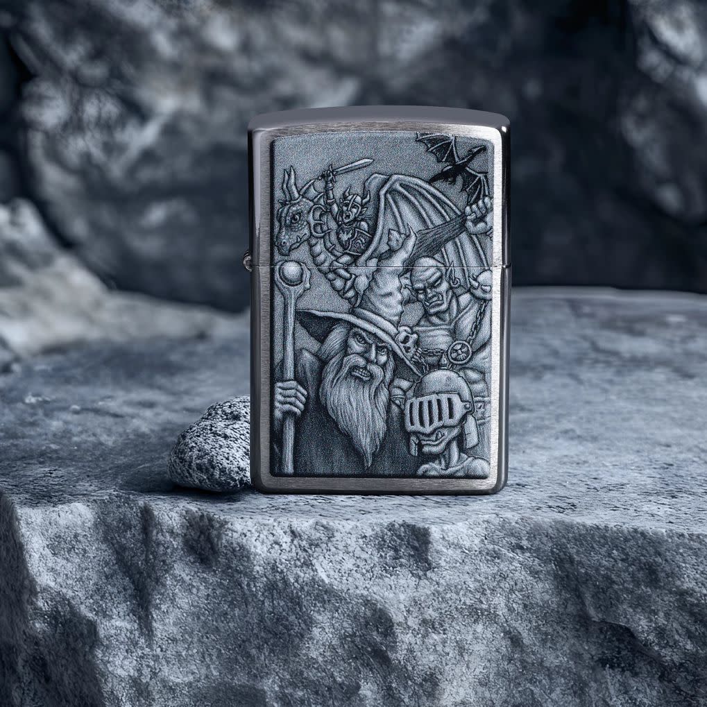 Lifestyle image of Zippo Mystical Beings Design Brushed Chrome Windproof Lighter standing on a rock with boulders in the background.