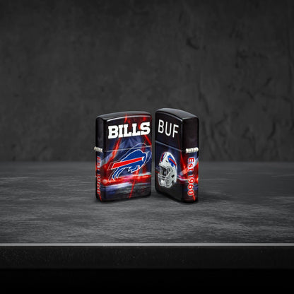 Lifestyle image of two Zippo NFL Buffalo Bills 540 Matte Windproof Lighters, one showing the front of the lighter and the other showing the back, standing on a dark grey surface.