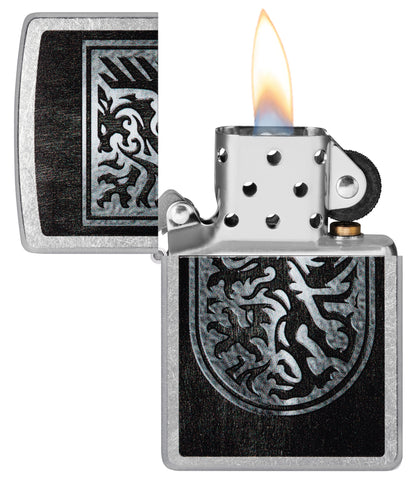 Zippo Dragon Shield Design Street Chrome Windproof Lighter with its lid open and lit.