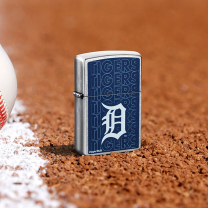 Lifestyle image of Zippo MLB® Detroit Tigers Street Chrome Windproof Lighter standing in the dirt on a baseball field.