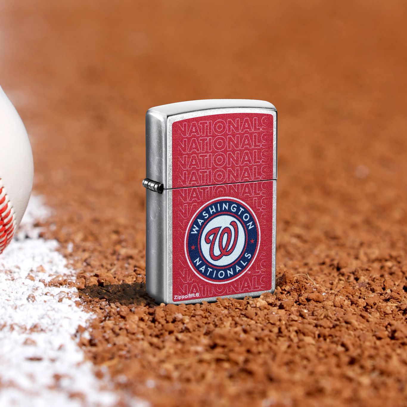 Lifestyle image of Zippo MLB® Washington Nationals Street Chrome Windproof Lighter standing in the dirt on a baseball field.