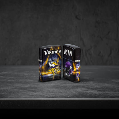 Lifestyle image of two Zippo NFL Minnesota Vikings 540 Matte Windproof Lighters, one showing the front of the lighter and the other showing the back, standing on a dark grey surface.