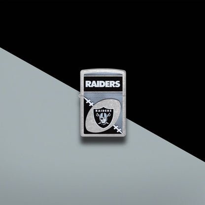 Lifestyle image of Zippo NFL Las Vegas Raiders Street Chrome Windproof Lighter set on a black and gray background.