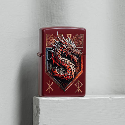 Lifestyle image of Zippo Dragon Shield Design Merlot Windproof Lighter standing on a light gray painted board next to a light gray painted concrete wall. 

