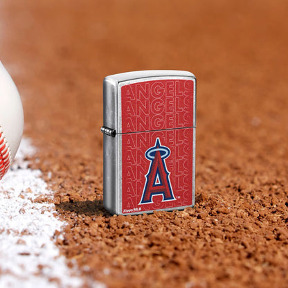 Lifestyle image of Zippo MLB® Los Angeles Angels Street Chrome Windproof Lighter standing in the dirt on a baseball field.