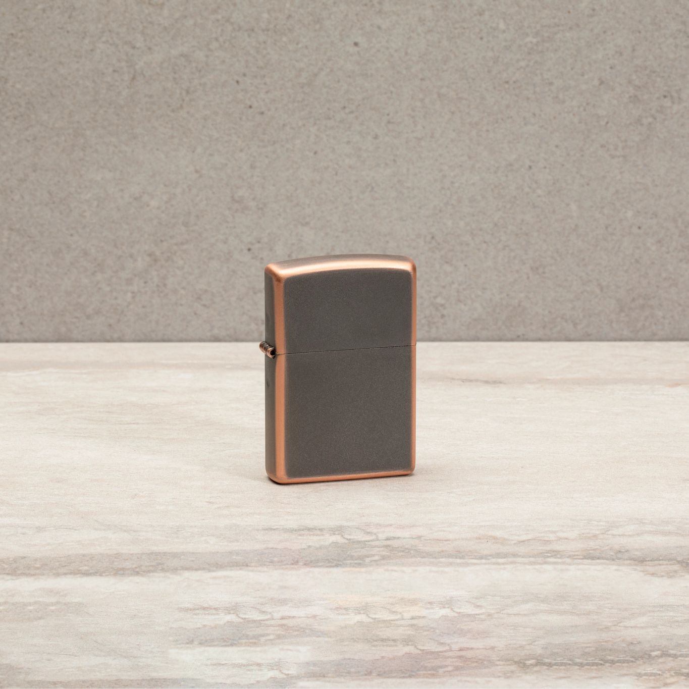 Lifestyle image of Classic Rustic Bronze Windproof Lighter standing on a countertop.