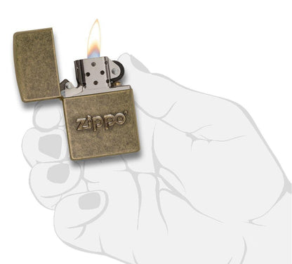 Zippo Stamp Antique Brass Lighter lit in hand.