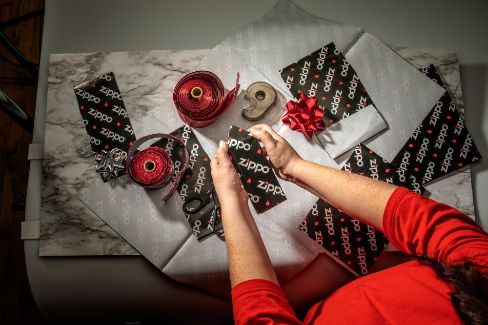 Person wrapping gifts with Zippo gift wrap