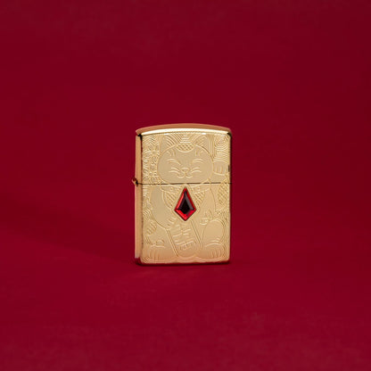 Lifestyle image of Lucky Cat Design Emblem Attached Armor® High Polish Brass Windproof Lighter standing in a red scene.