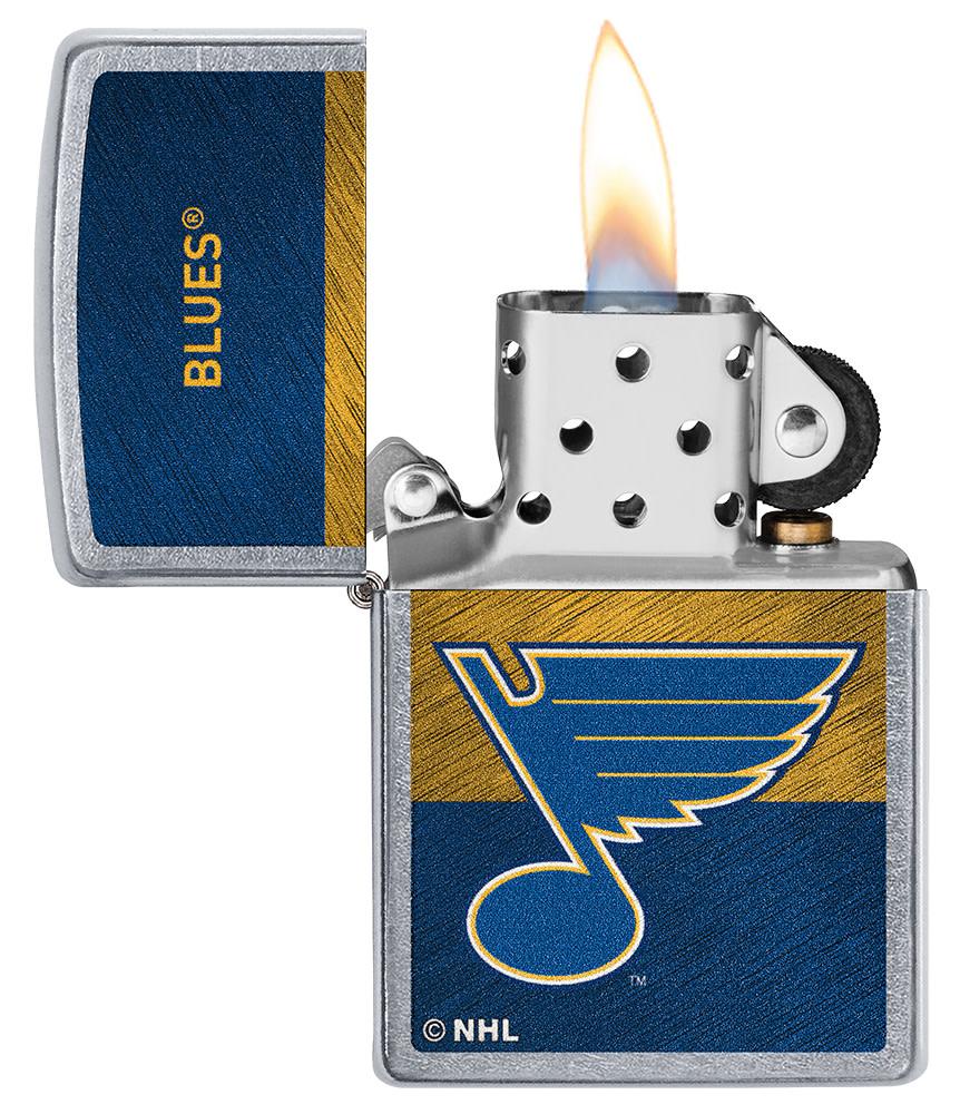 NHL® St Louis Blues Street Chrome™ Windproof Lighter with its lid open and lit