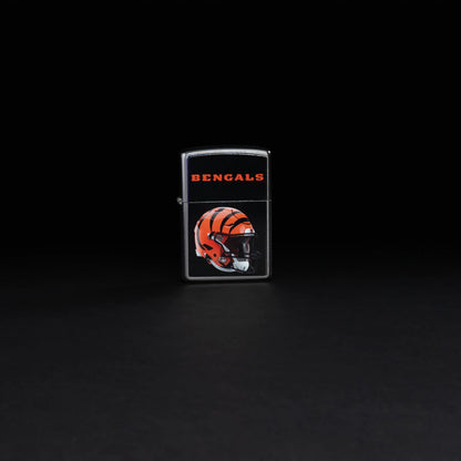 Lifestyle image of NFL Cincinnati Bengals Helmet Street Chrome Windproof Lighter standing in a black background.