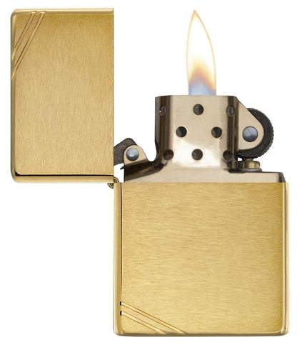 Brushed Brass Vintage with Slashes Windproof Lighter with its lid open and lit