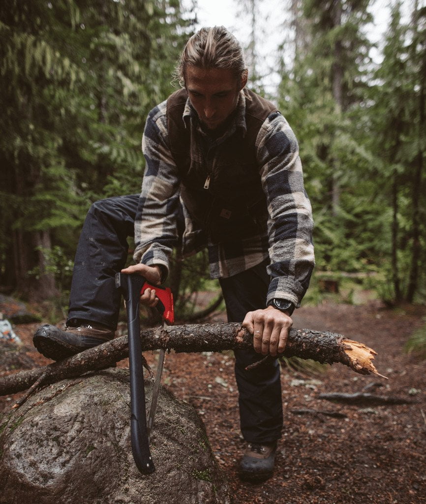 Lifestyle image of man in the woods using the AxeSaw saw