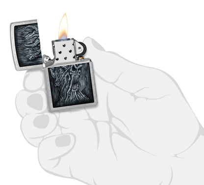 Zippo Evil Tree Design Street Chrome Windproof Lighter lit in hand.