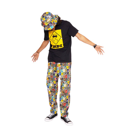 Lifestyle image of man wearing the Zippo x SKIDZ Pants and the Zippo x SKIDZ Bucket Hat.