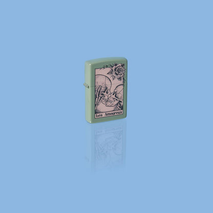 Glamour shot of Zippo Death Kiss Design Sage Windproof Lighter standing in a blue scene.