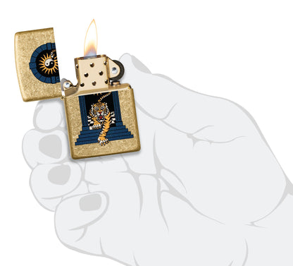 Zippo Tiger Tattoo Design Tumbled Brass Windproof Lighter lit in hand.