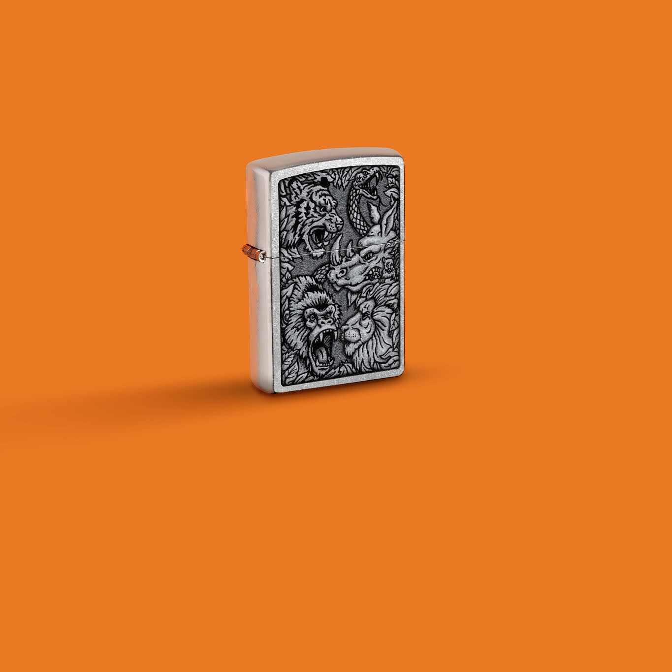 Glamour shot of Zippo Jungle Design Street Chrome Windproof Lighter standing in a orange scene.