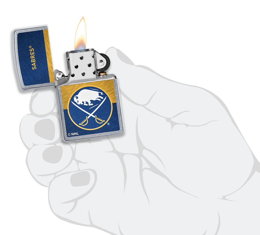 NHL® Buffalo Sabre Street Chrome™ Windproof Lighter lit in hand