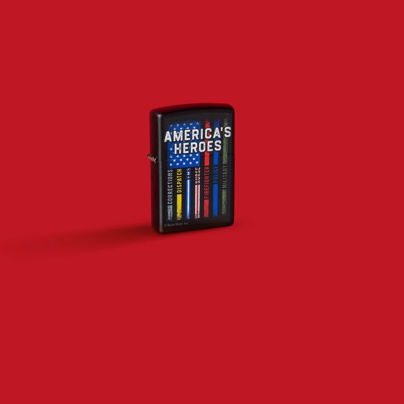 Glamour shot of Zippo Buckwear America's Heroes Design Black Matte Windproof Lighter standing in a red scene.