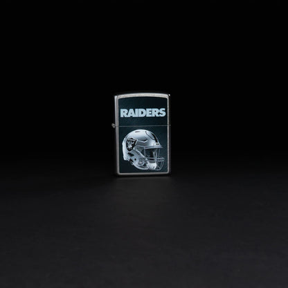 Lifestyle image of NFL Las Vegas Raiders Helmet Street Chrome Windproof Lighter standing in a black bacground.