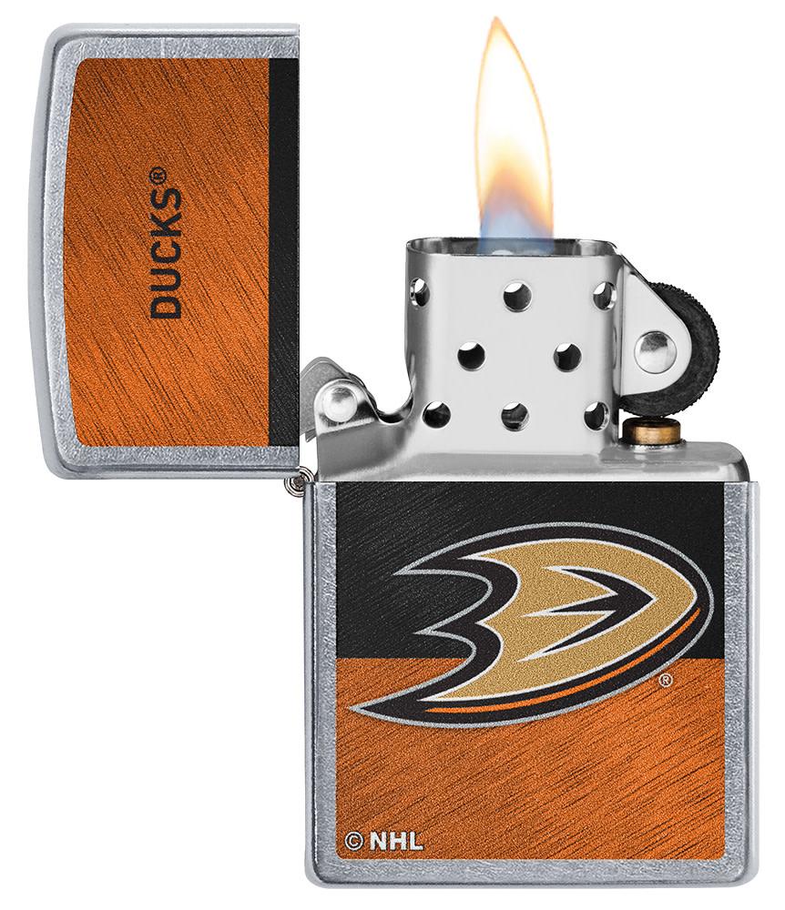 NHL® Anaheim Ducks Street Chrome™ Windproof Lighter with its lid open and lit