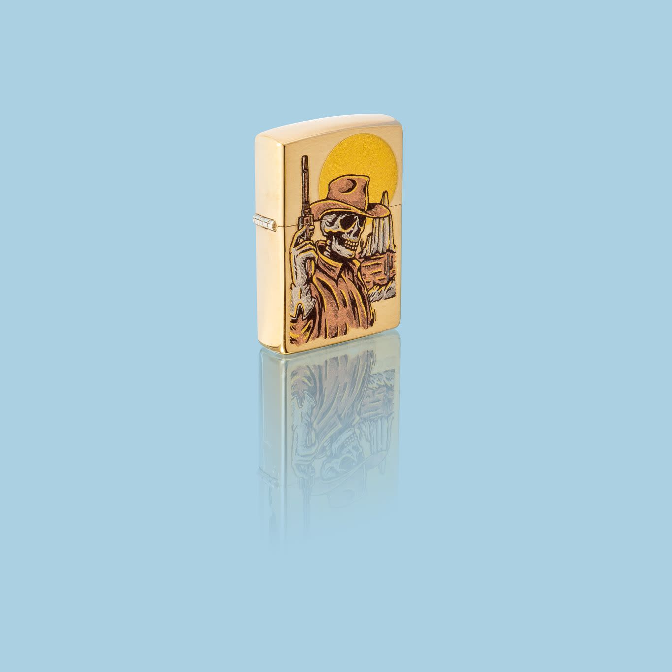 Glamour shot of Zippo Wild West Skeleton Design Brushed Brass Windproof Lighter standing in a blue scene.