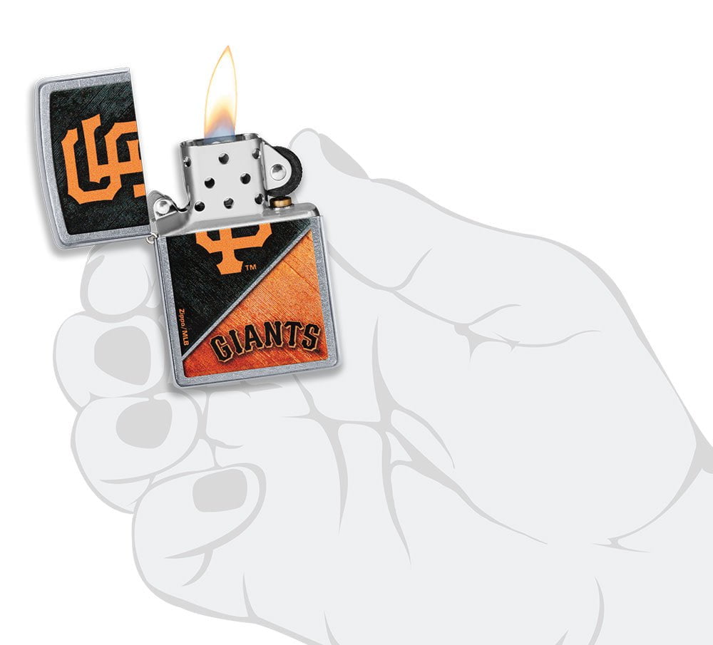 MLB® San Francisco Giants™ Street Chrome™ Windproof Lighter lit in hand.